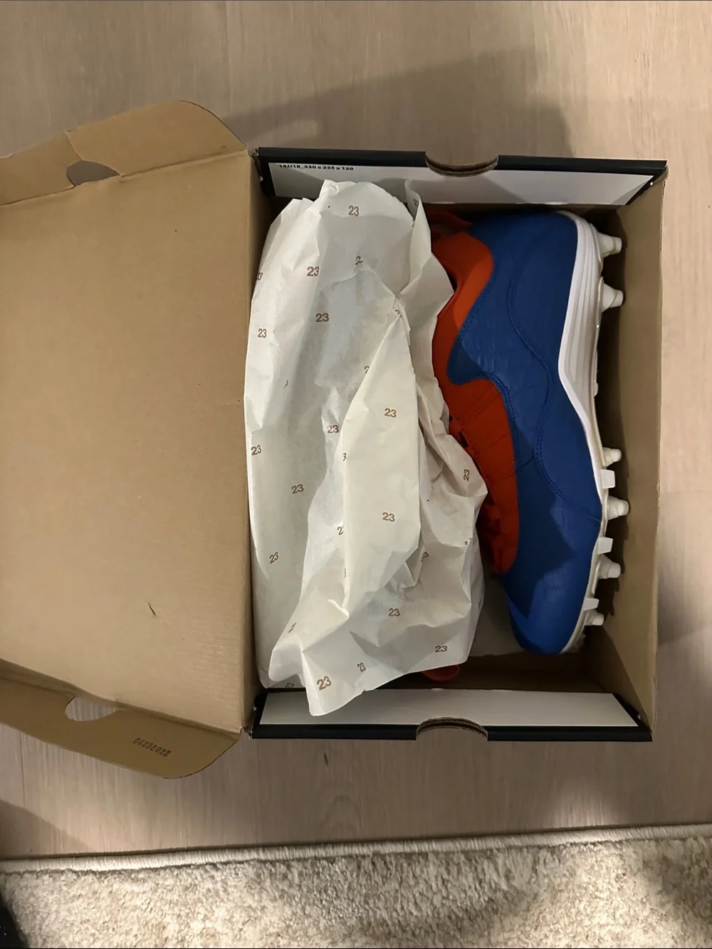 Custom Florida Air Jordan Cleats in Orange and Blue.